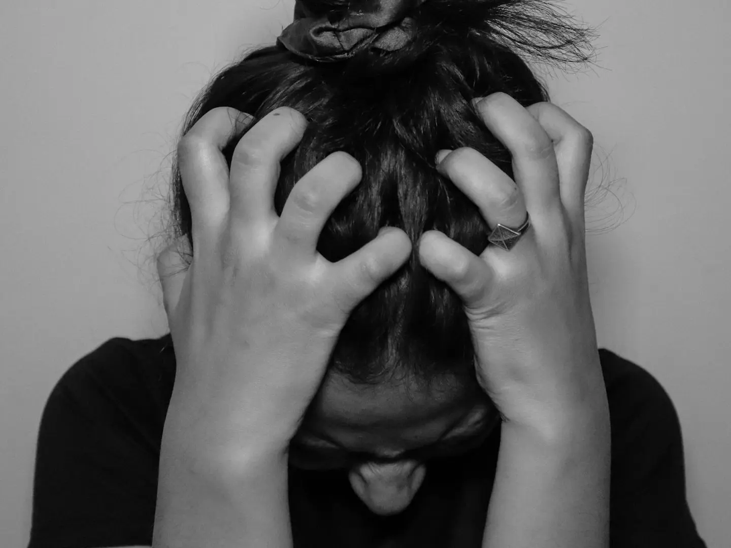 a woman covering her face with her hands